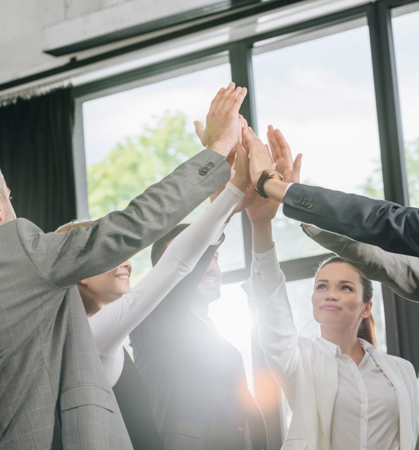 businesspeople giving high five after training in hub